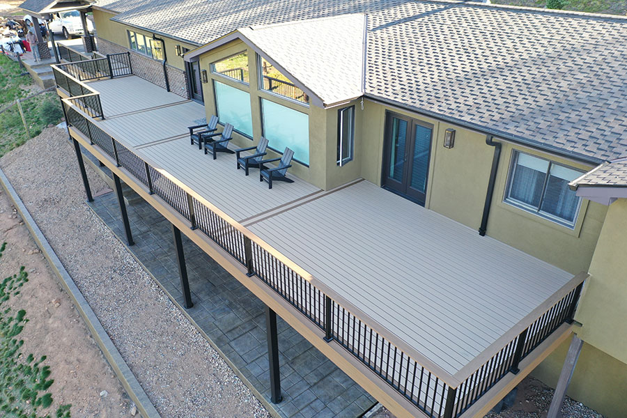 Conifer, CO custom built Trex deck with black aluminum railing and steel framing plus 1,000 sq ft Stamped concrete patio below with steps.