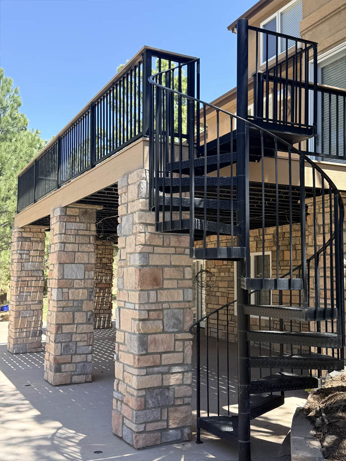 Trex Deck with spiral staircase, aluminum Black-metal Railing, steel-framing, stone columns and stamped concrete patio 